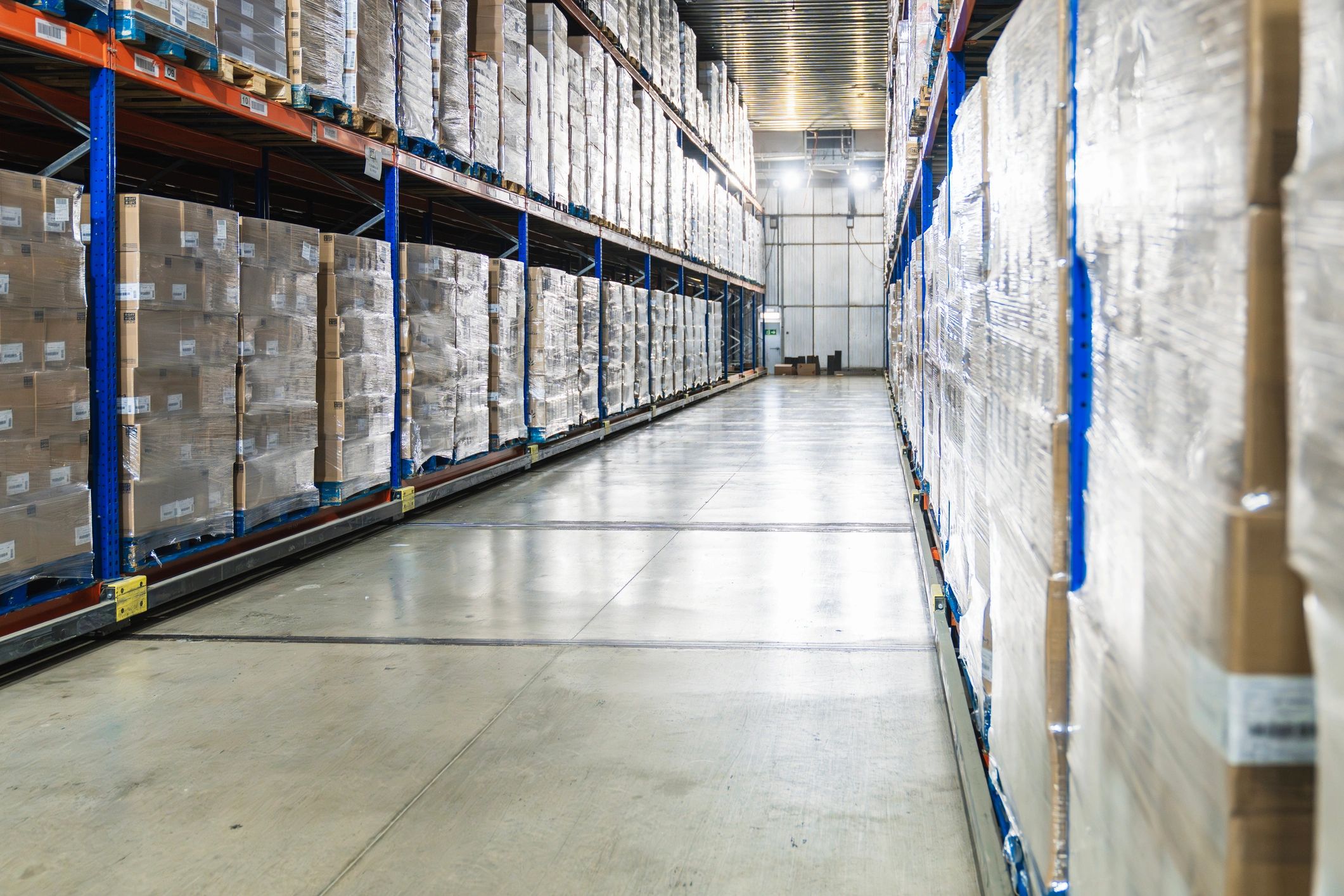 Warehouse aisle with pallets and boxes
