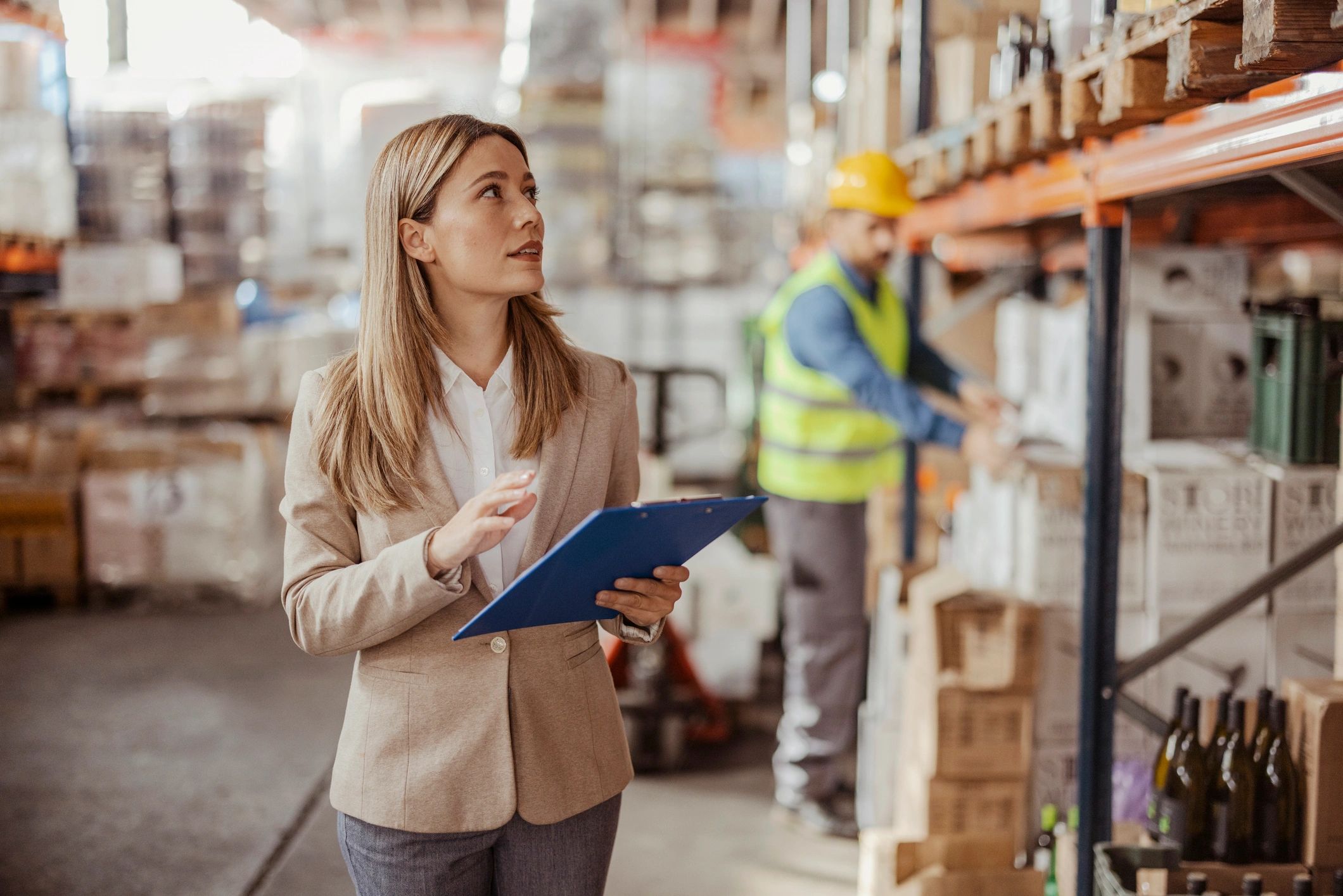 Supervisor reviewing inventory and shipment details in a warehouse